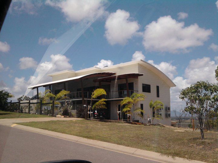 A Large White House Sits On Top Of A Hill — Aaron Lee Painting Pty Ltd In Douglas, QLD