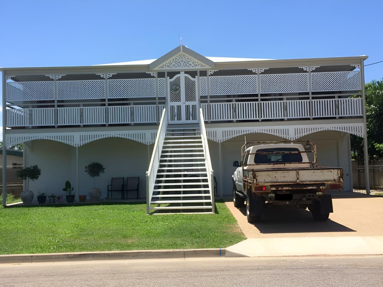A Truck Is Parked In Front Of A House With Stairs — Aaron Lee Painting Pty Ltd In Jensen, QLD