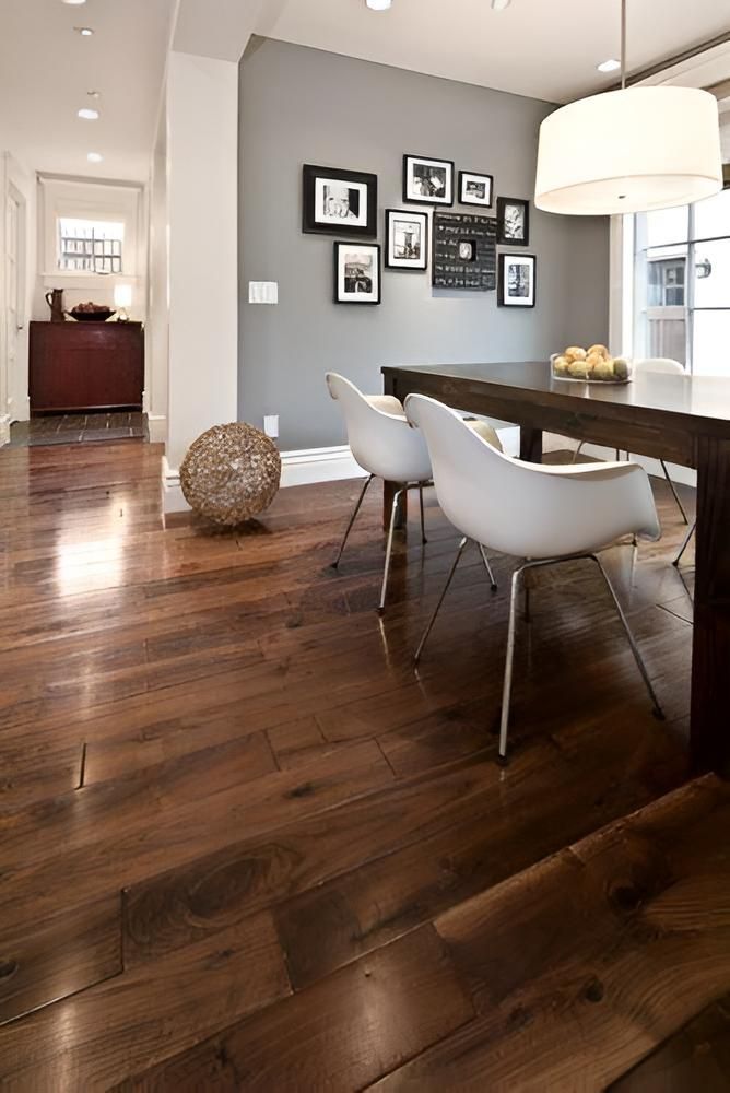 A Dining Room With A Wooden Table And Chairs And A Gray Wall — Aaron Lee Painting Pty Ltd In Jensen, QLD