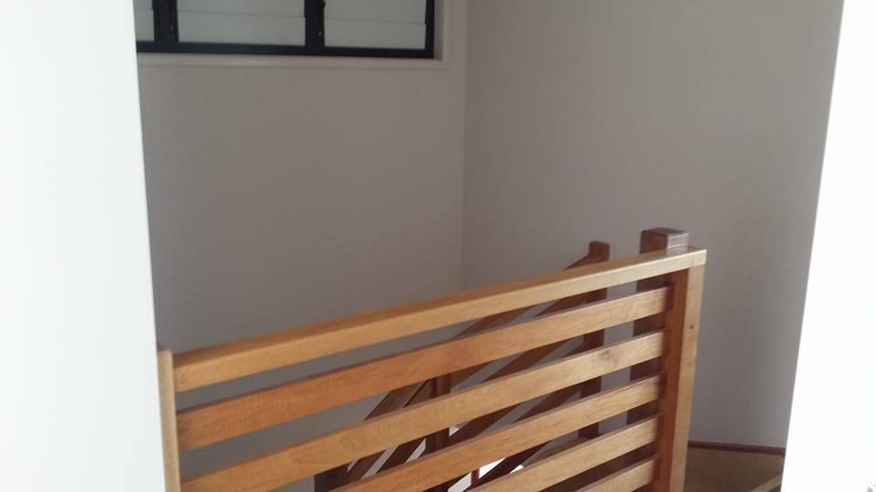 A Wooden Railing On A Staircase In A House — Aaron Lee Painting Pty Ltd In Jensen, QLD