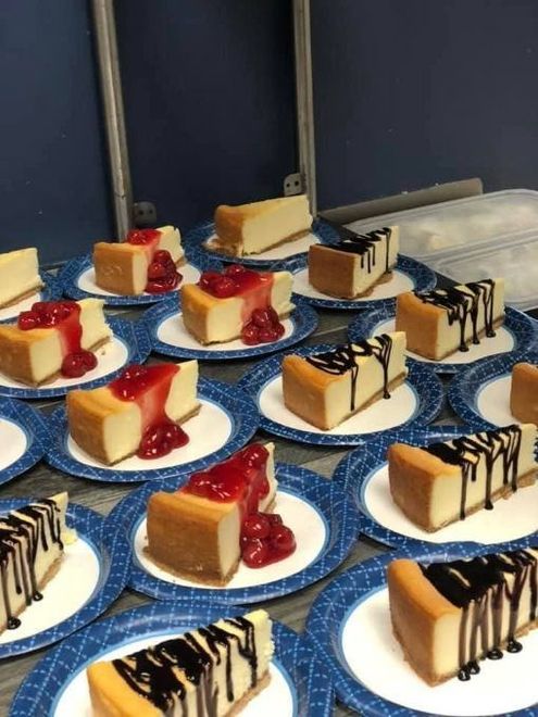 Assorted small plated desserts with caramel and chocolate drizzle on a blue tablecloth