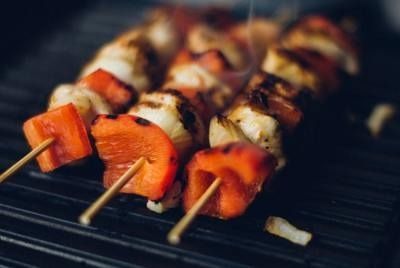 Grilled skewers of chicken and red bell pepper on a barbecue grill