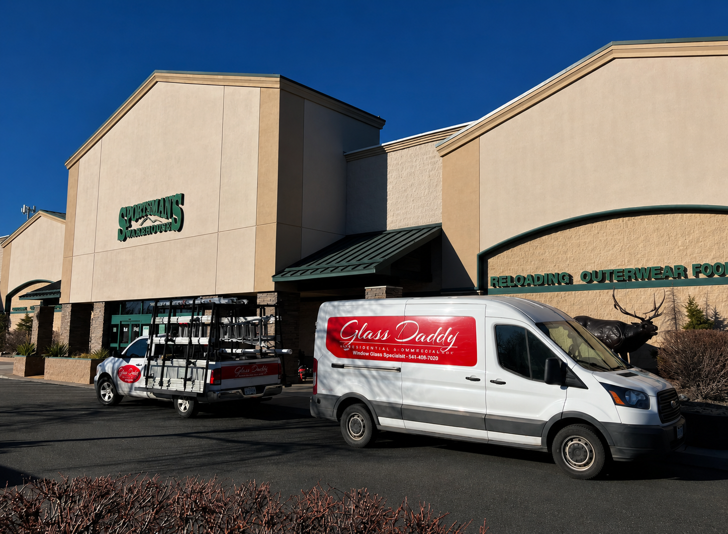 Glass Daddy Redmond vans parked outside of Sportsmans Warehouse for a Commercial Glass repair.