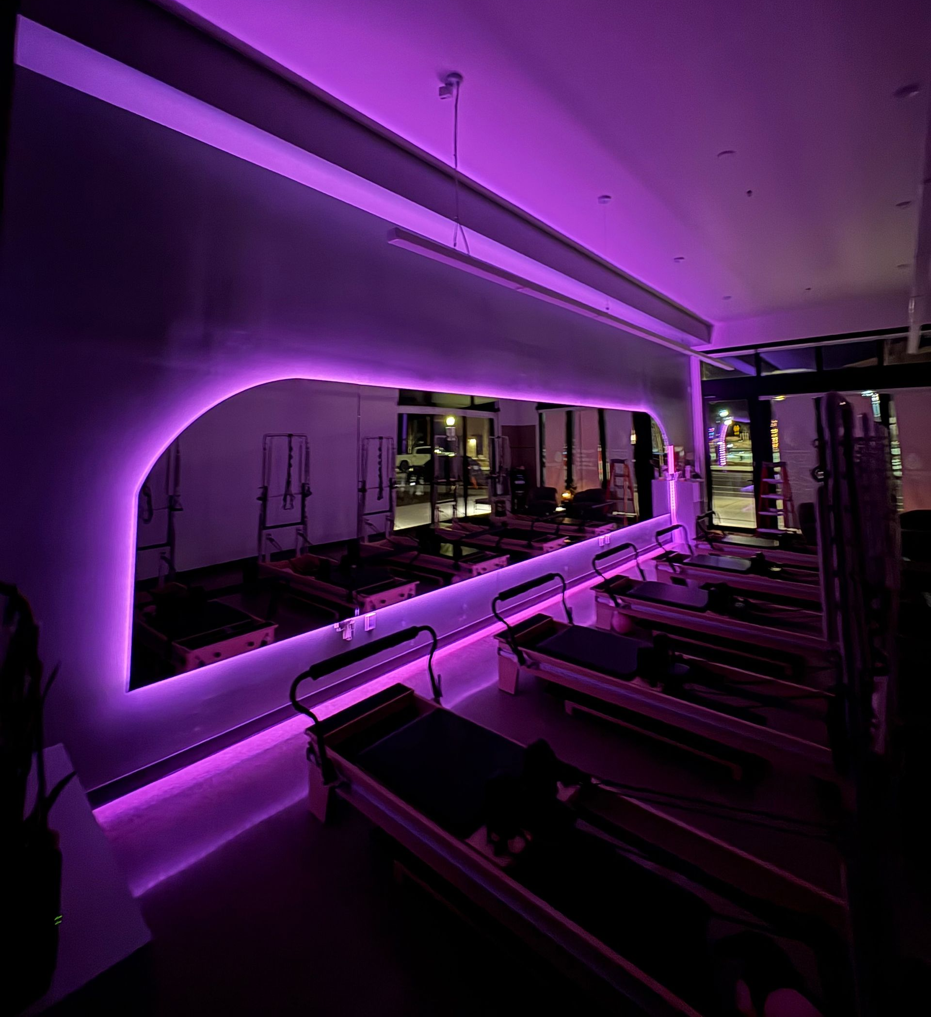 Large custom wall mirror with purple LED in a Pilates studio - Glass Daddy OR