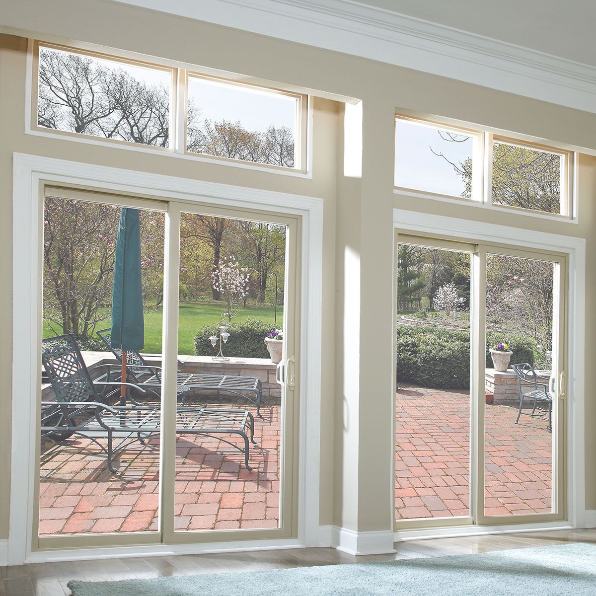 Large sliding glass patio doors opening onto a brick patio - Glass Daddy Redmond OR
