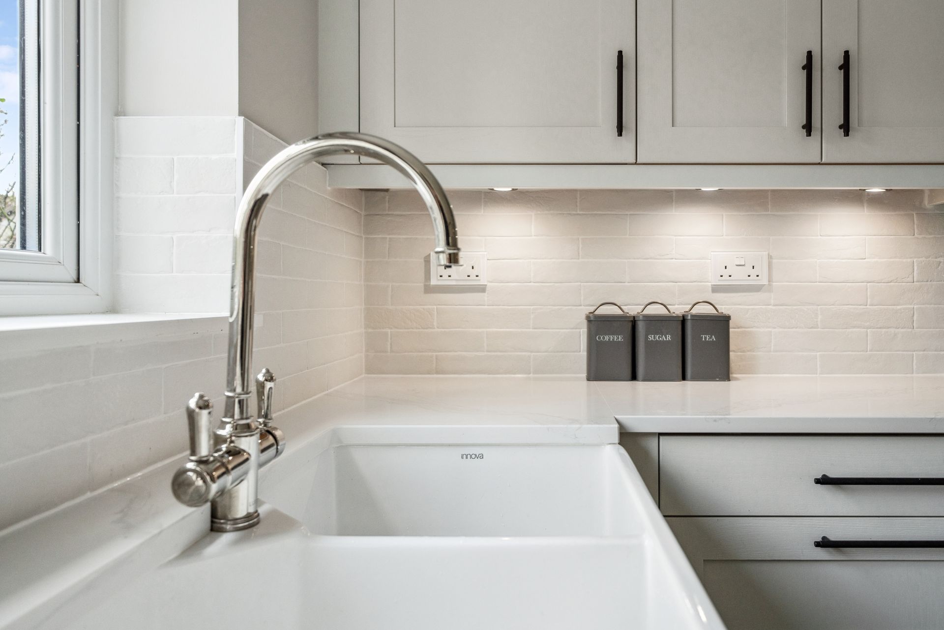 Modern kitchen with white cabinets and white worktop