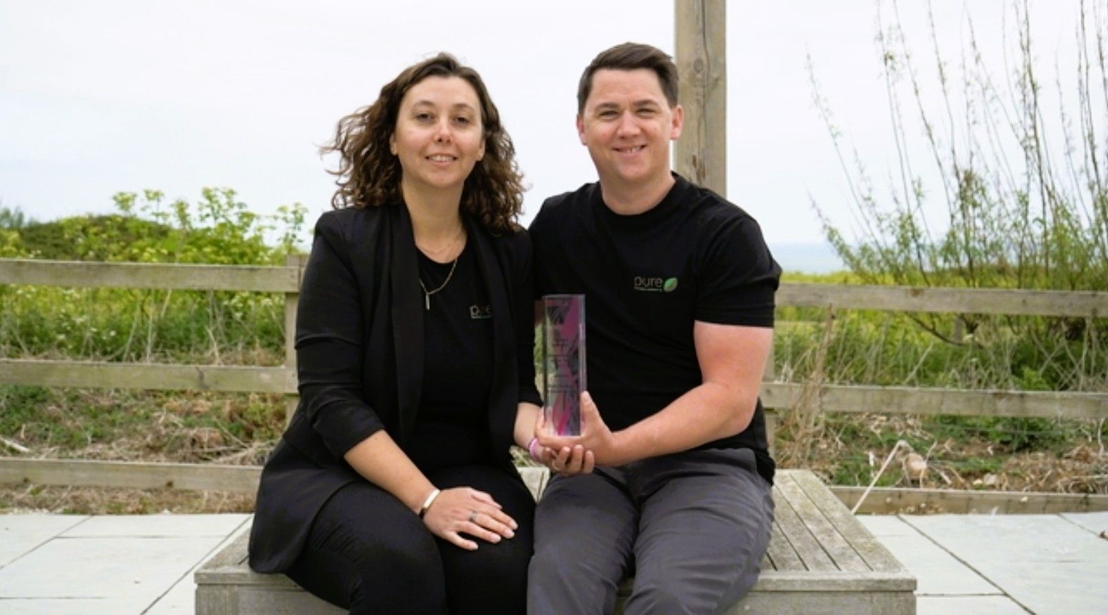 Award for Pure Kitchen & Carpentry, both Mike and Amelia holding award.