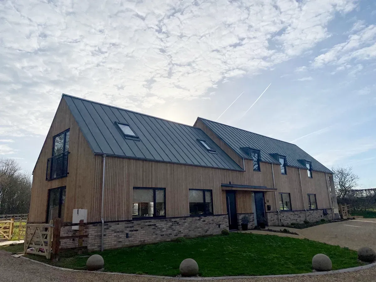 A large house with a metal roof and a lot of windows