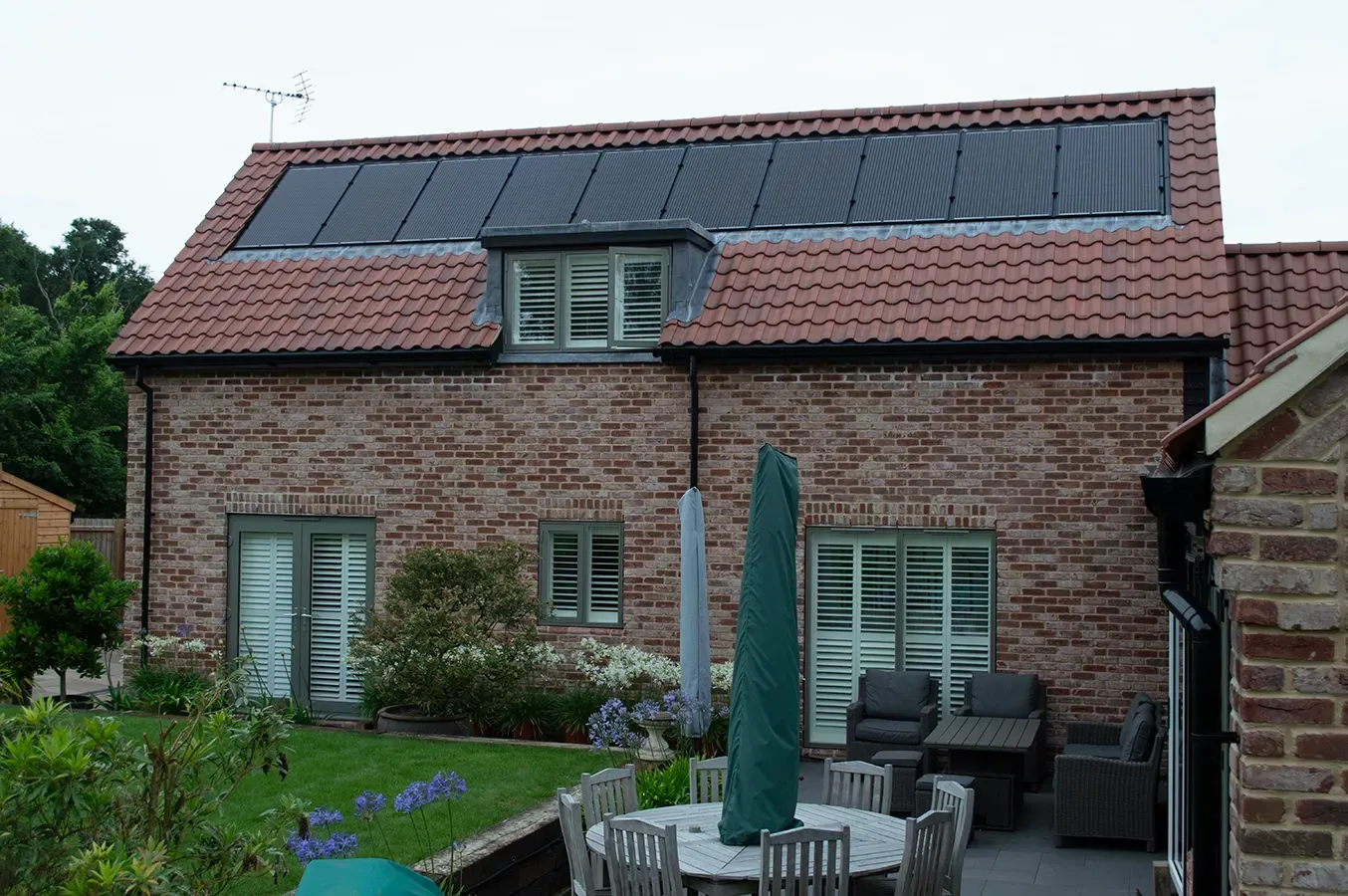 A brick house with solar panels on the roof