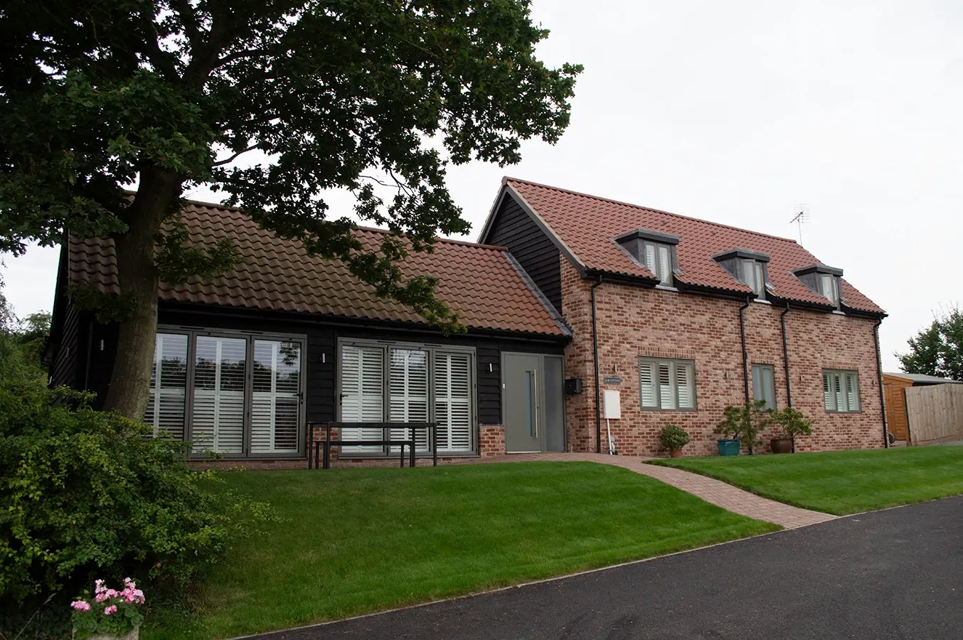A large brick house with shutters on the windows