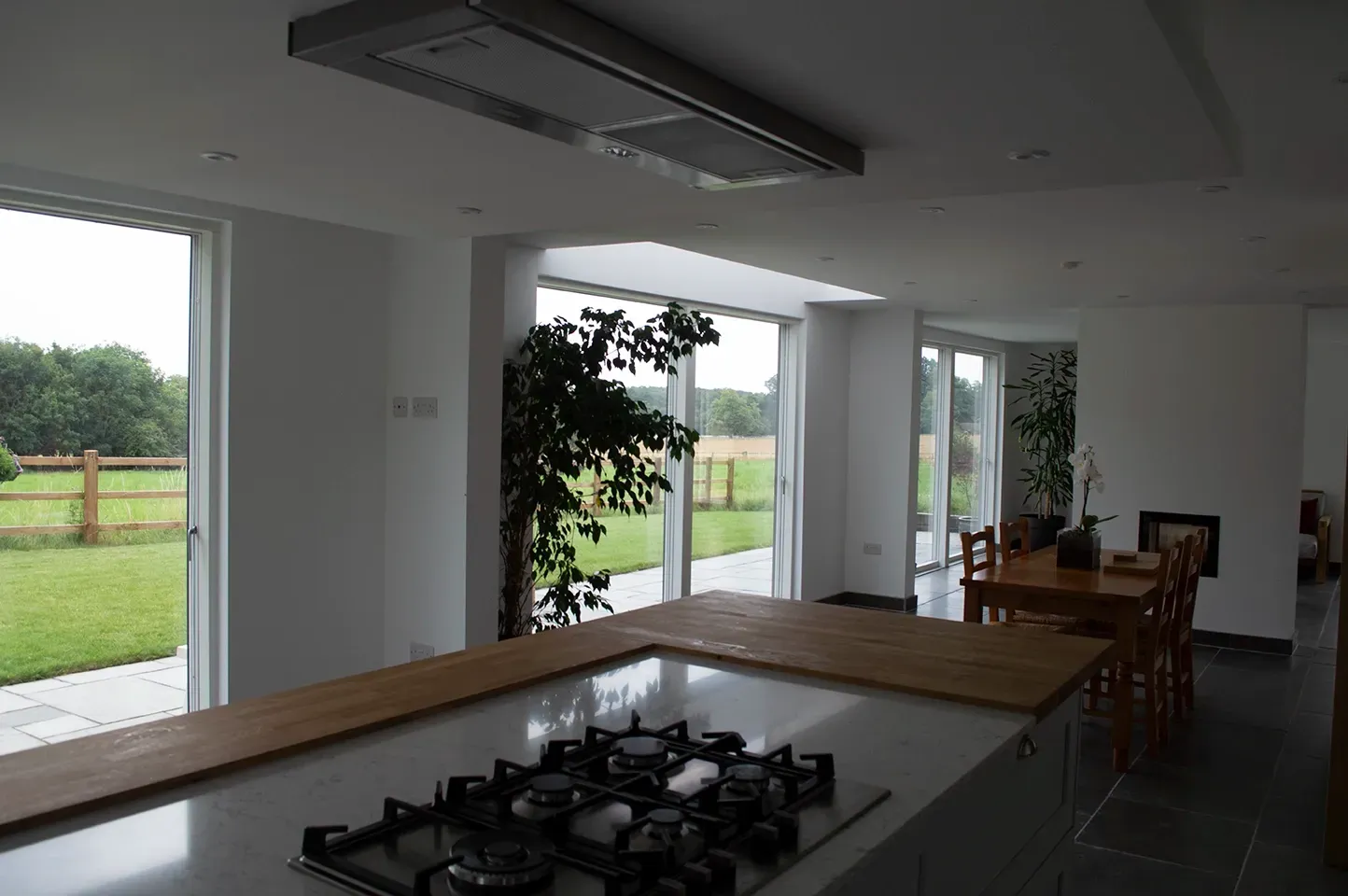 A kitchen with a stove top oven and sliding glass doors