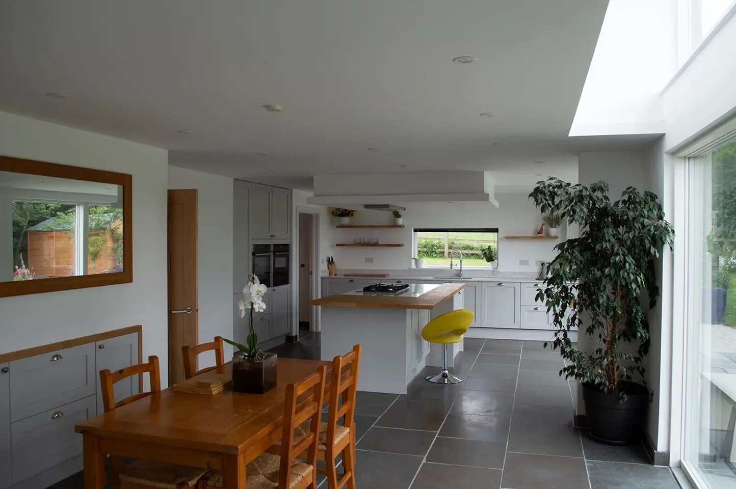 A kitchen with a table and chairs in it