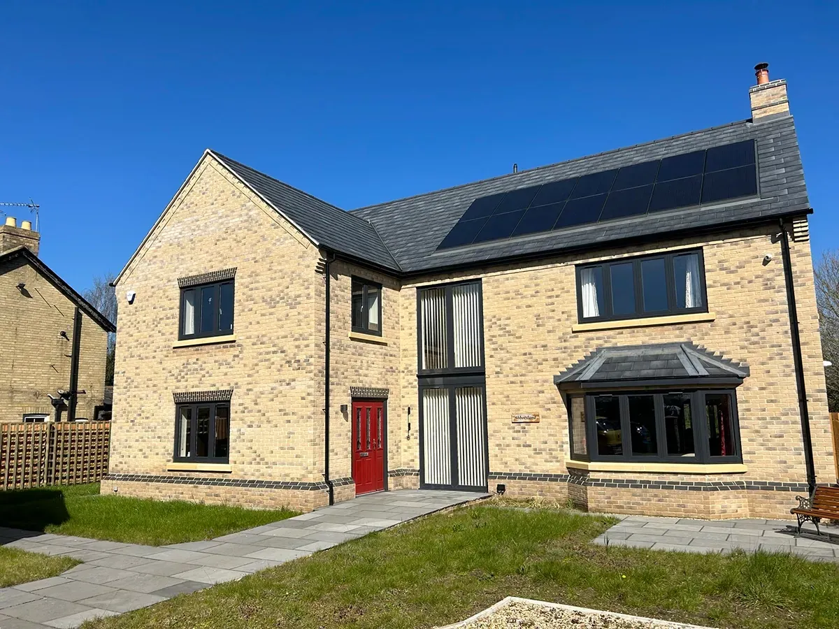 A large brick house with solar panels on the roof.
