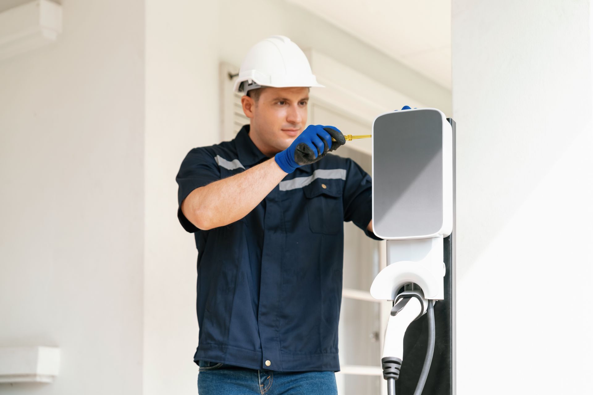 A technician installing a home EV charging station.