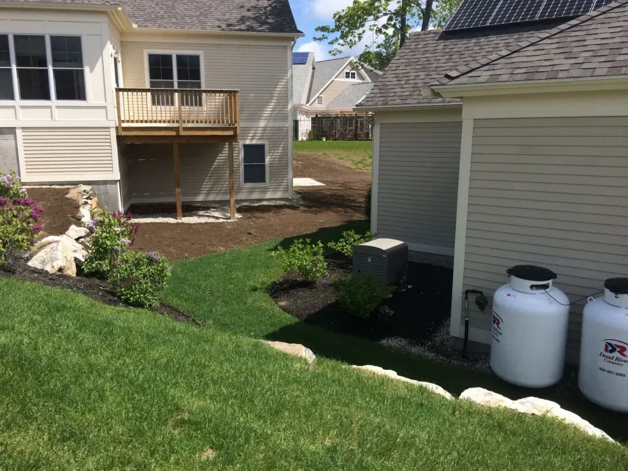 A house with two propane tanks in front of it
