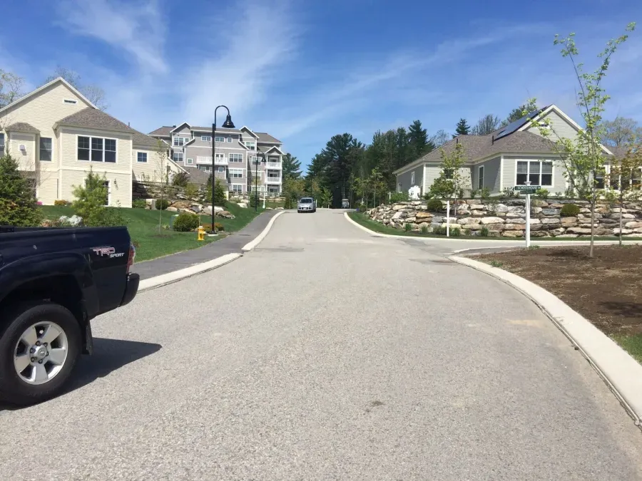 A truck is parked on the side of a road in a residential area.