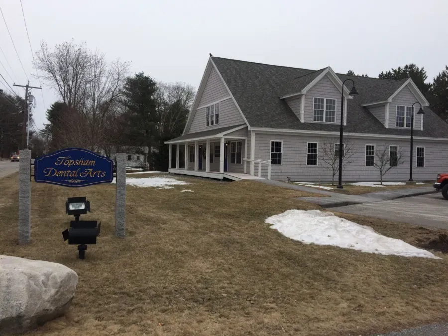 A large house with a sign in front of it that says master dental arts