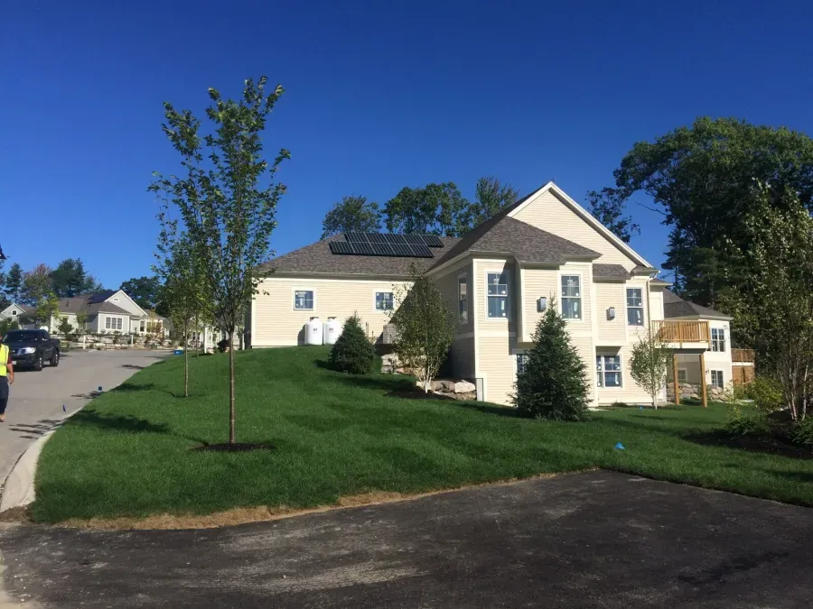 A large house with a lush green lawn in front of it