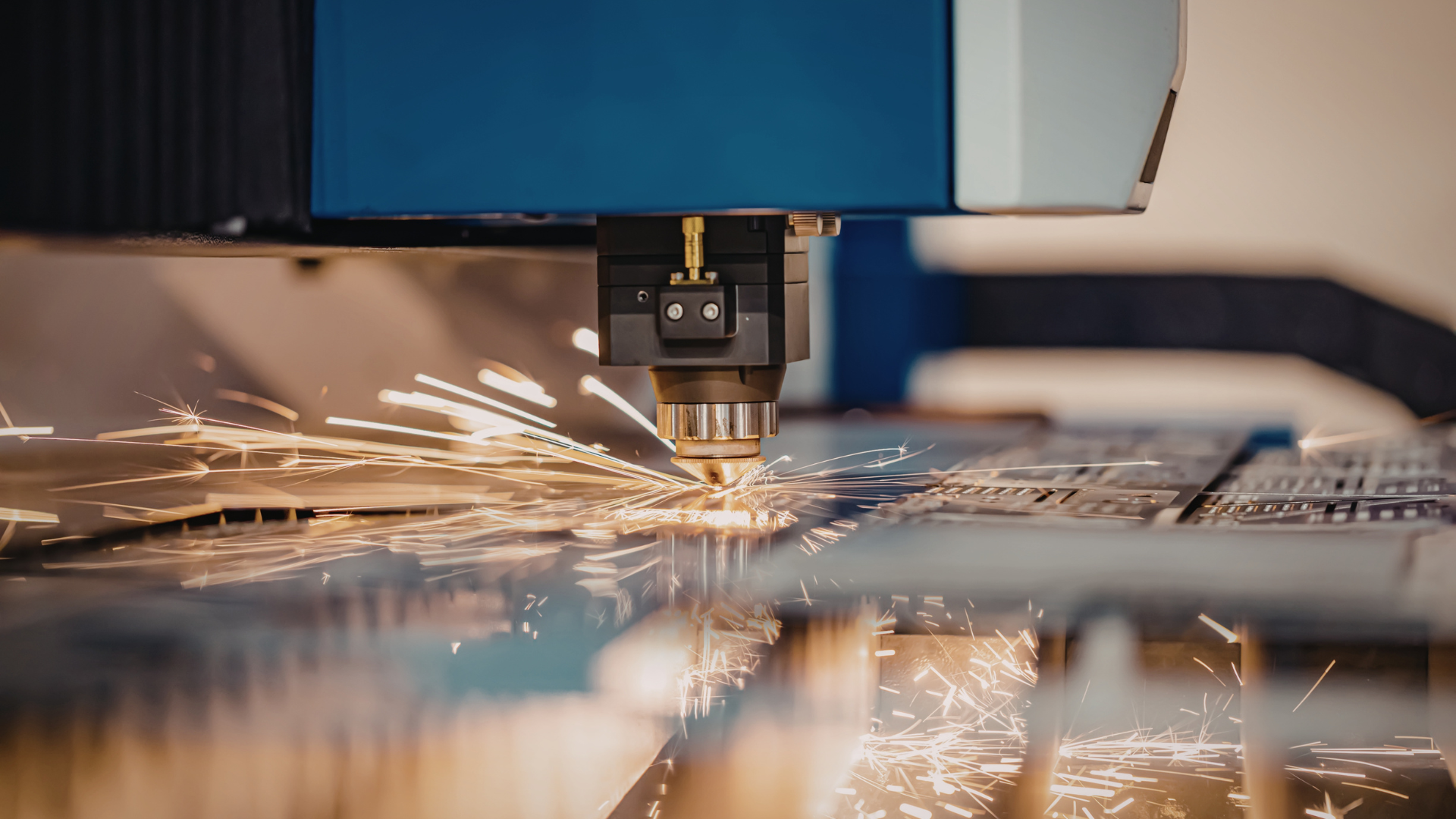 CNC machine cutting metal, sending bright sparks across a workshop surface.