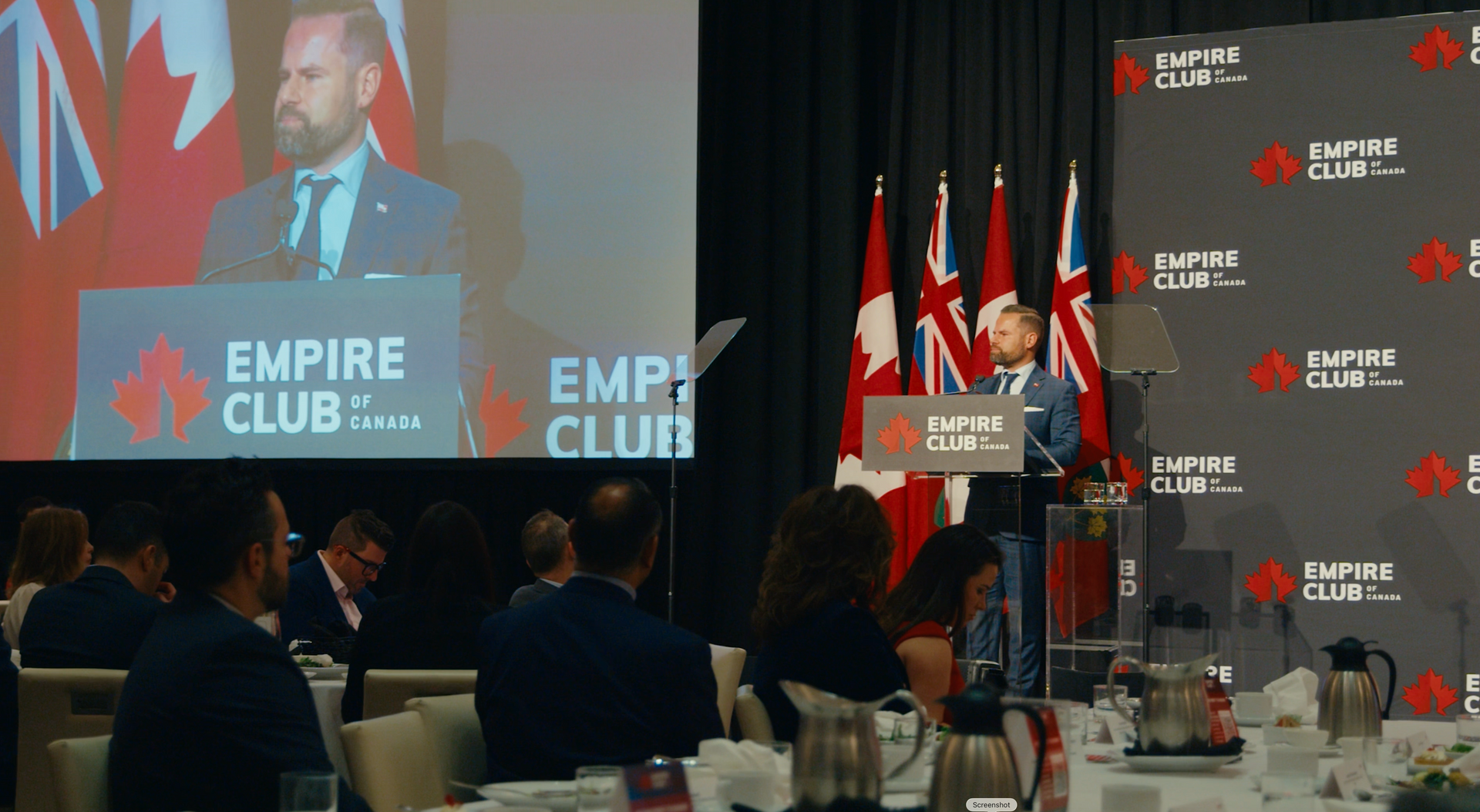 Man speaking at a podium with 