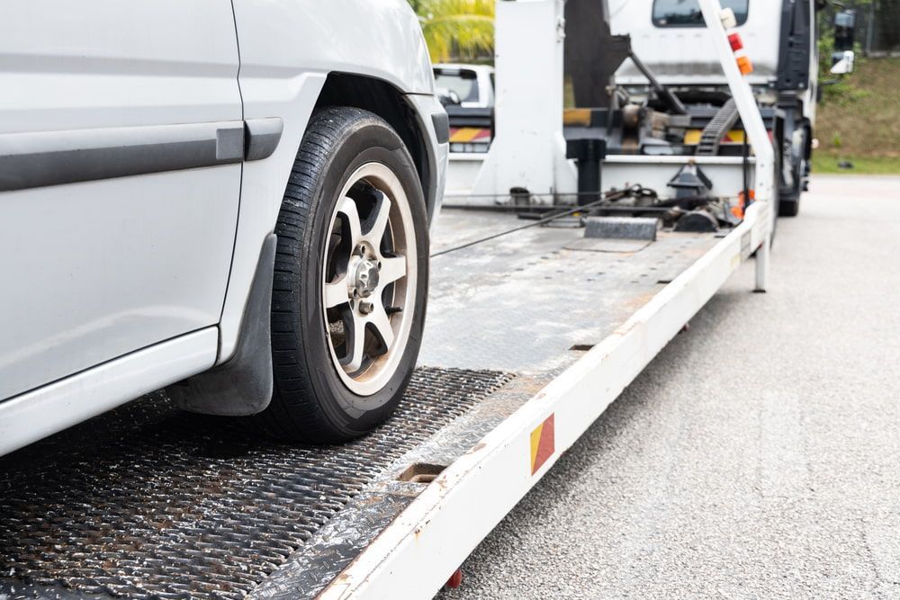 A Car is Being Towed by a Tow Truck — Mareeba Express Towing in Mareeba, QLD