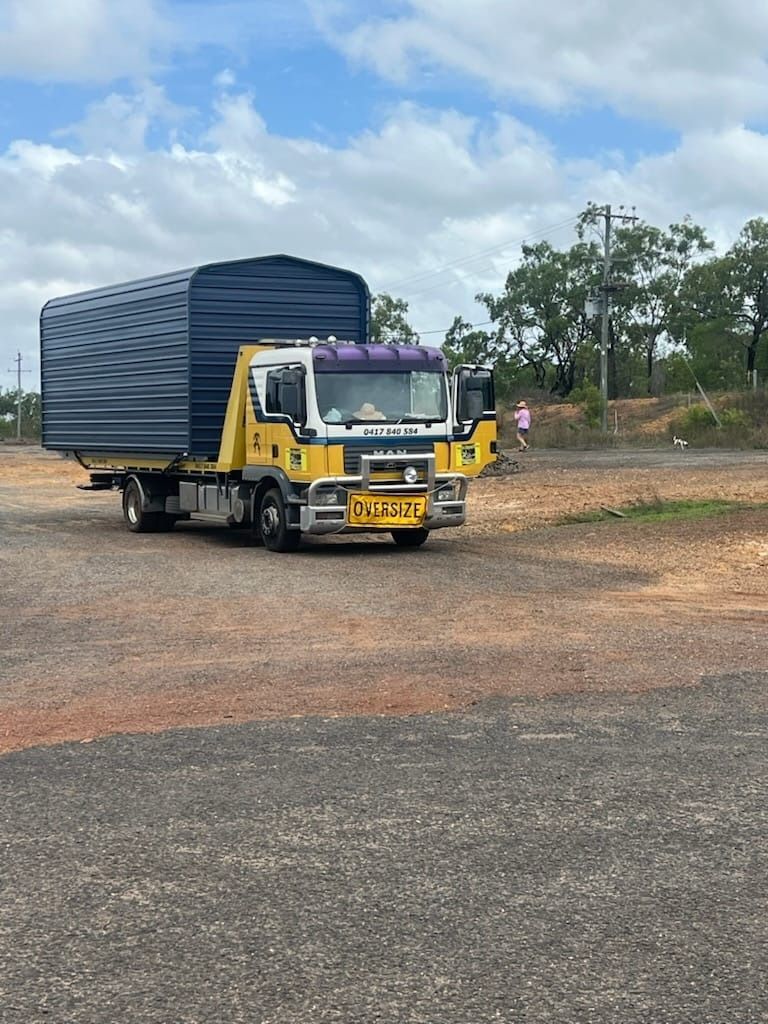 A Tow Truck is Towing a Car on the Highway — Mareeba Express Towing in Mareeba, QLD
