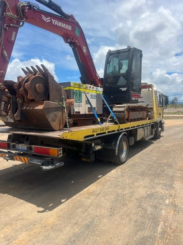 A Man is Towing a Car on a Tow Truck — Mareeba Express Towing in Mareeba, QLD