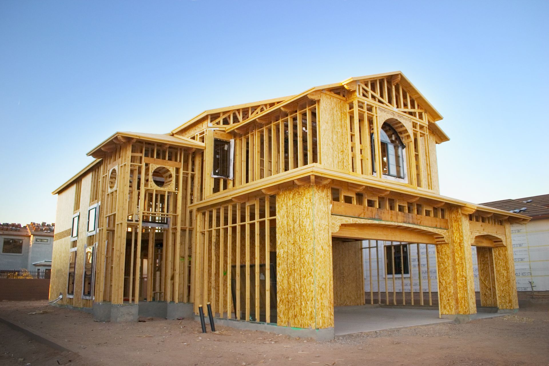 A large wooden house is being built in the desert.