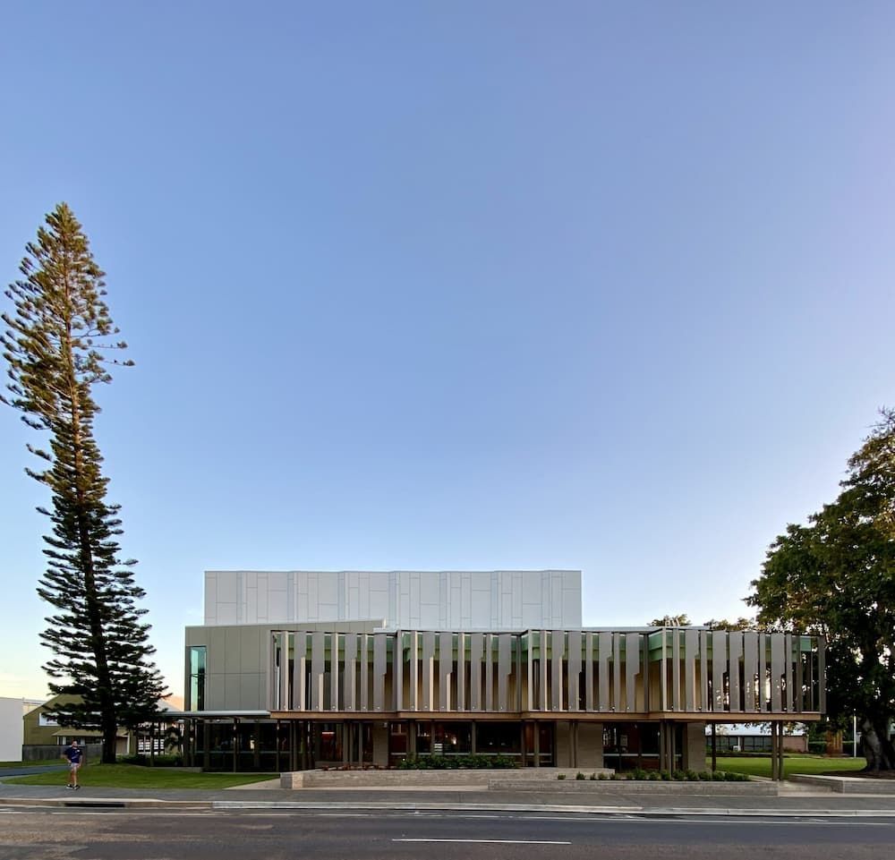 A Large Building With A Blue Sky in the Background — Proserpine Electrical Services in Airlie Beach, QLD