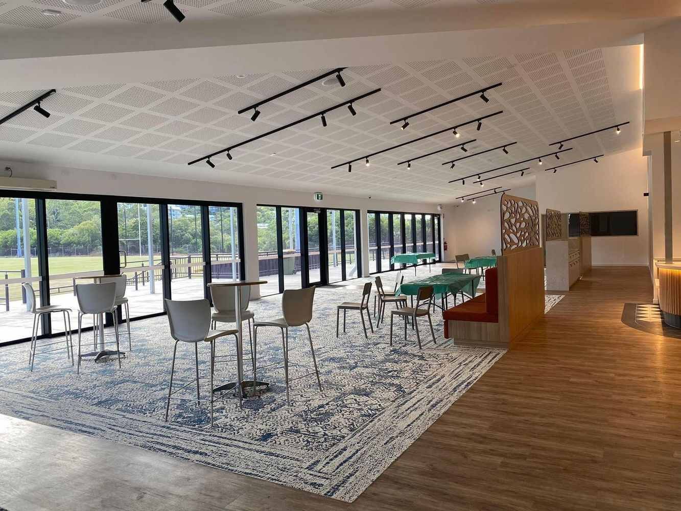 Large Room With Tables and Chairs and a Lot of Windows — Proserpine Electrical Services in Proserpine, QLD