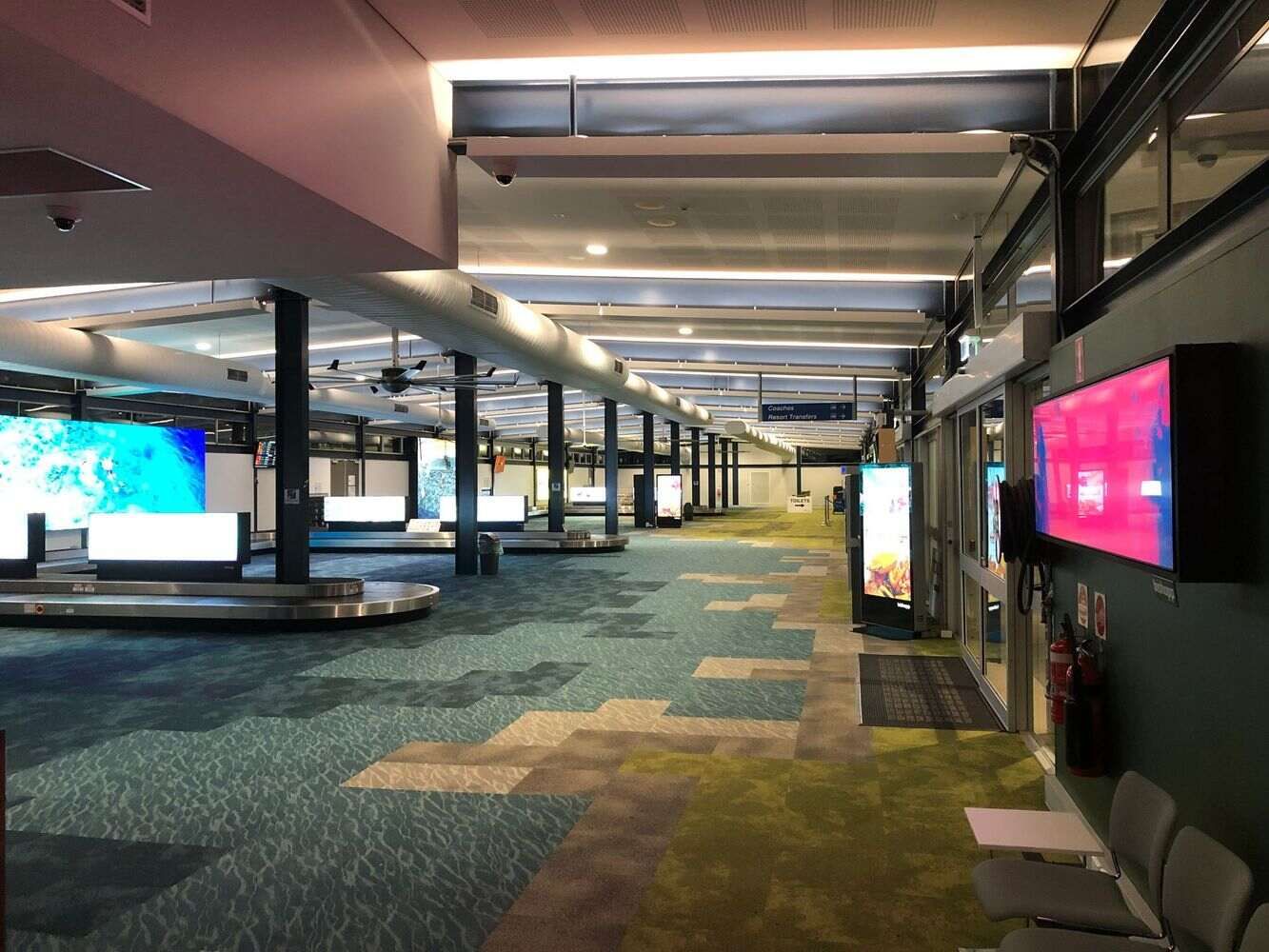 Long Hallway in an Airport With a Lot of Lights on the Ceiling — Proserpine Electrical Services in Proserpine, QLD