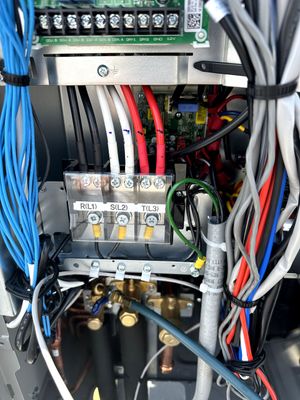 Electrical control panel with wiring, terminal blocks, and circuit components in a metal cabinet