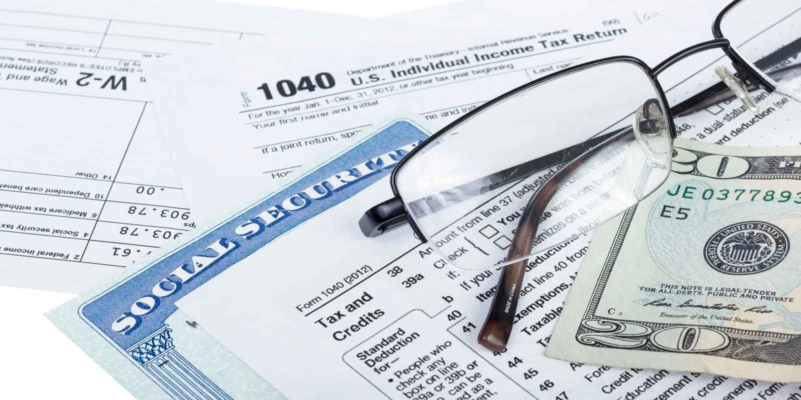 A pair of glasses is sitting on top of a social security card.