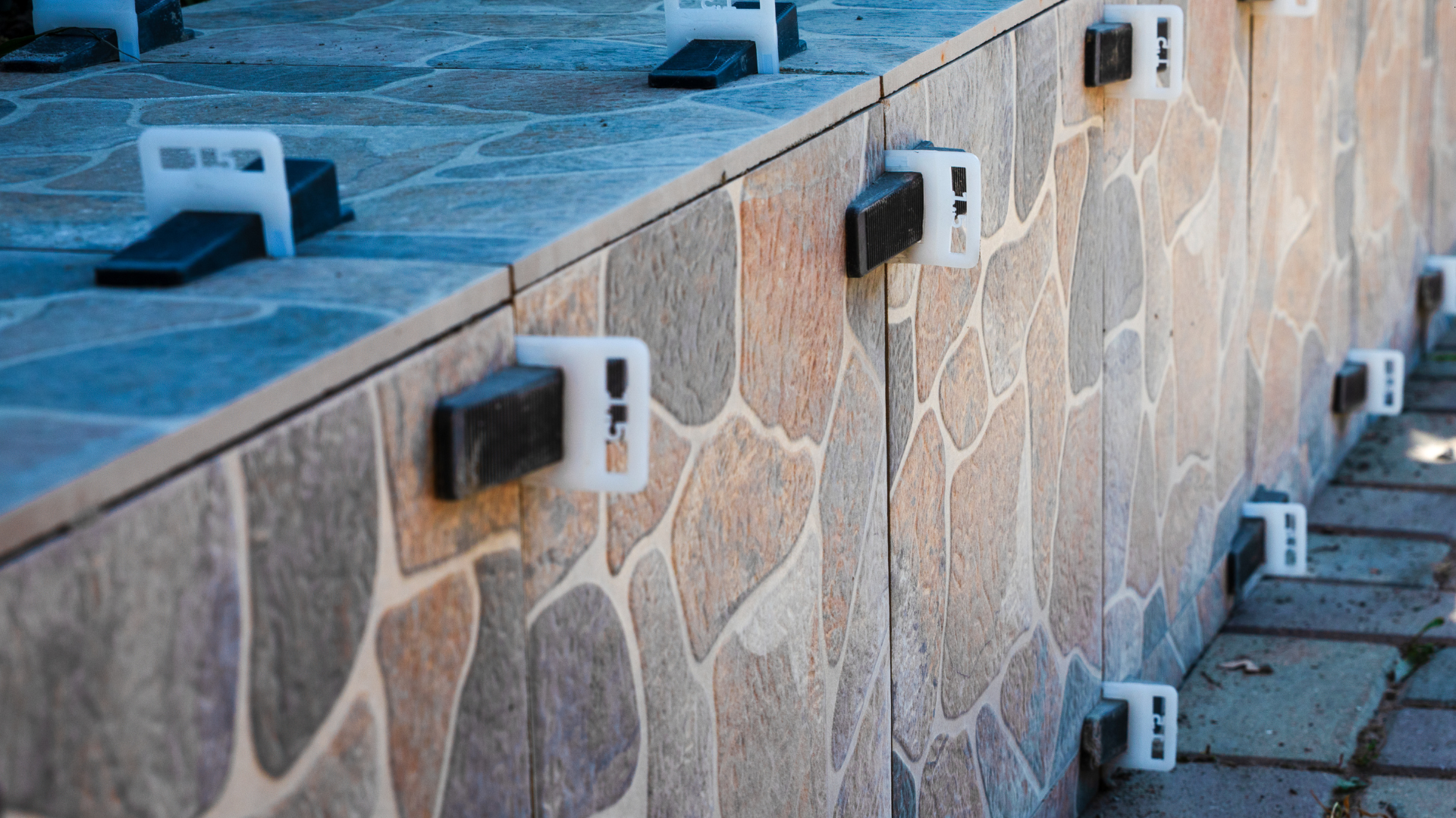 Tiles with leveling clips in place during installation.
