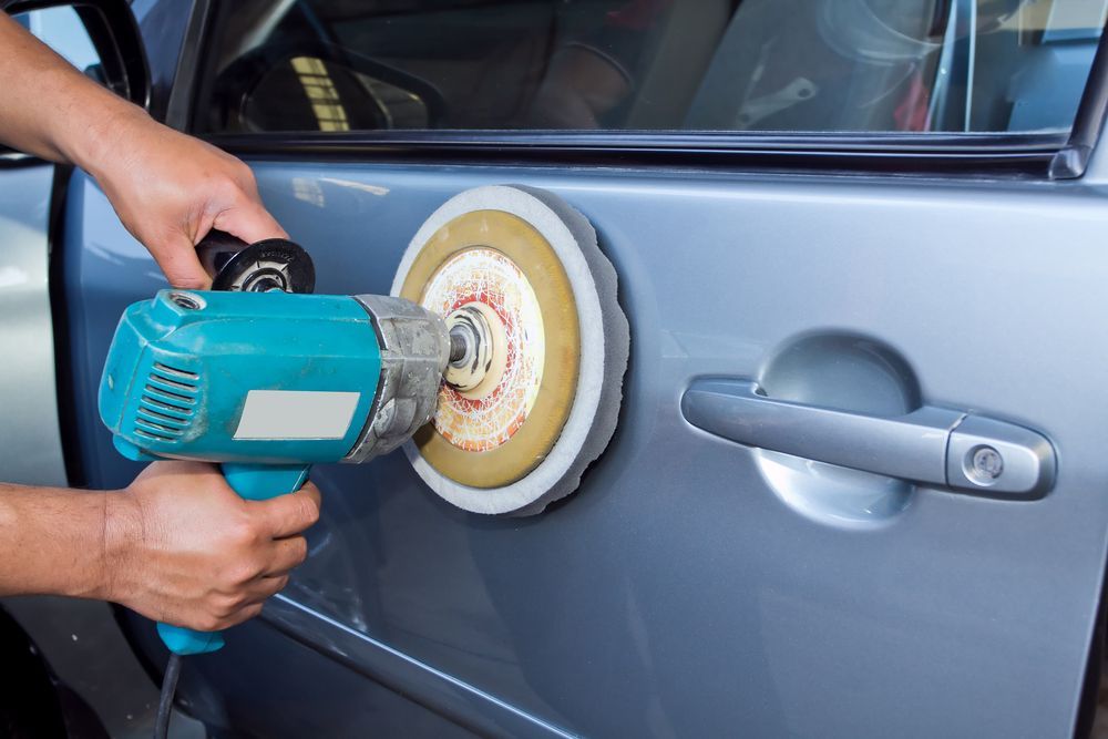 A Person Is Polishing A Car With A Machine — PK Crash Repairs In Ciccone, NT