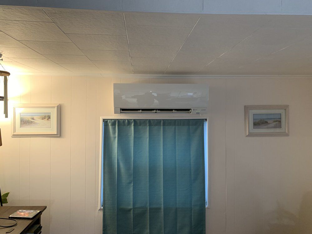 A living room with a blue curtain and a ceiling fan.