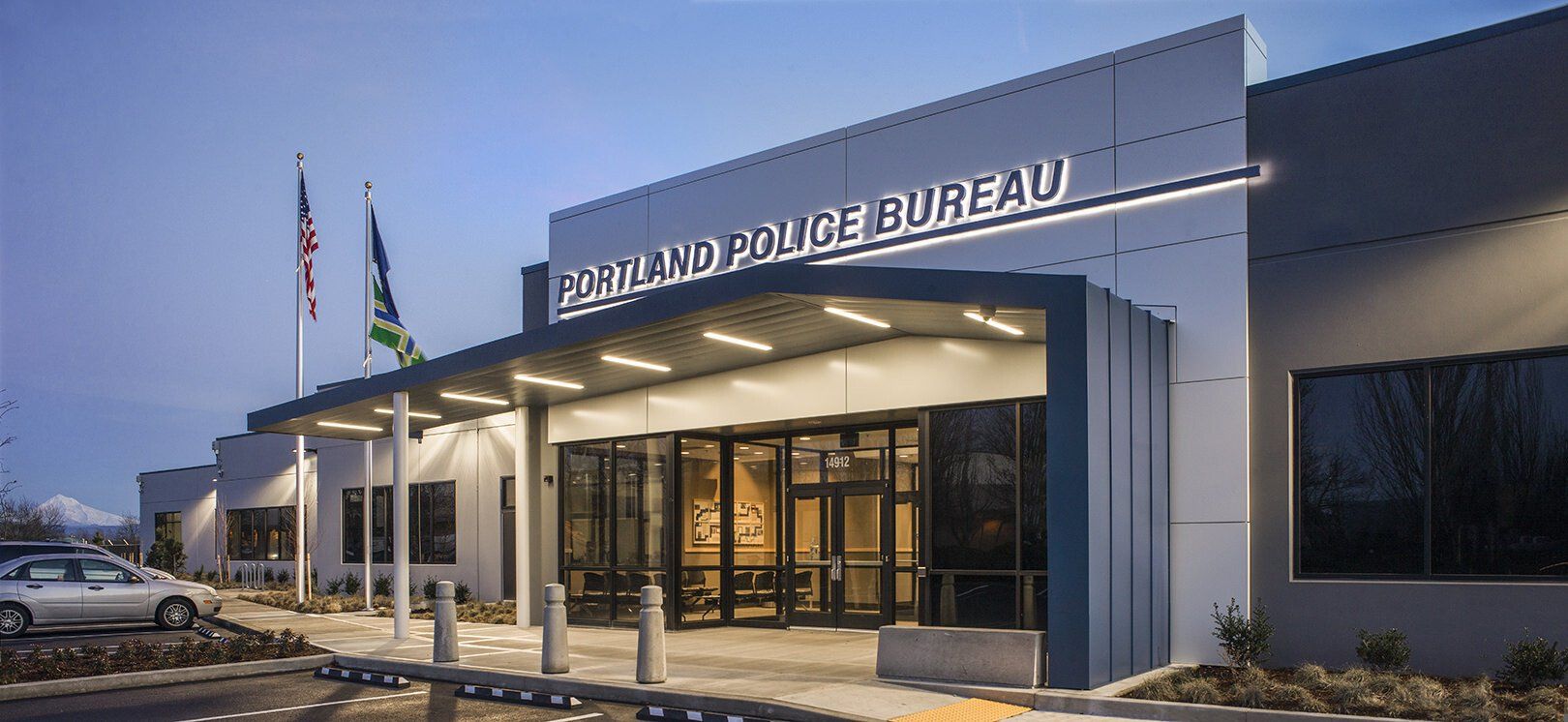 Exterior of the Portland Police Bureau building with American and Oregon state flags.