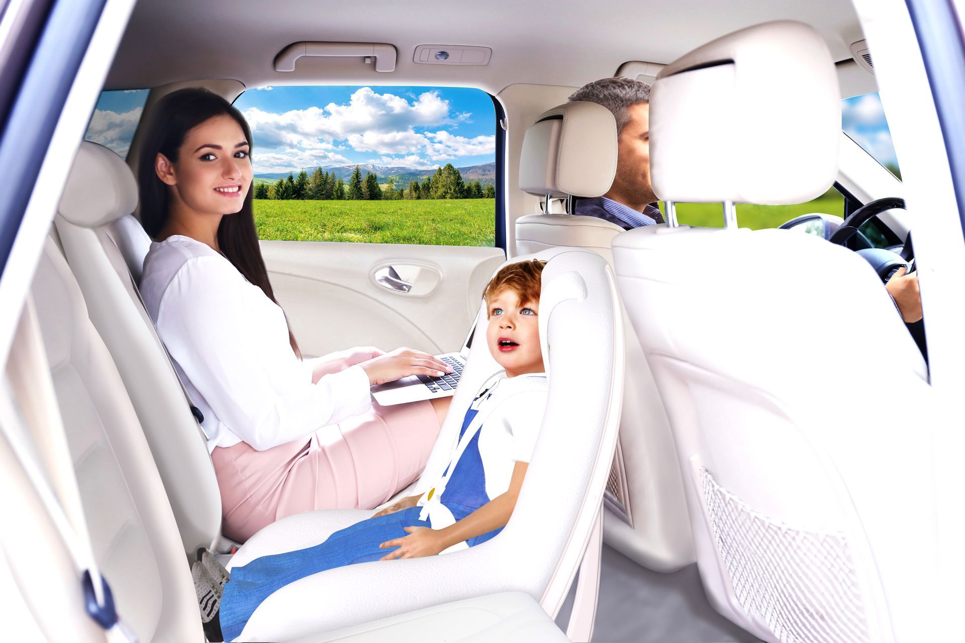 A woman is sitting in the back seat of a car with a child in a car seat.