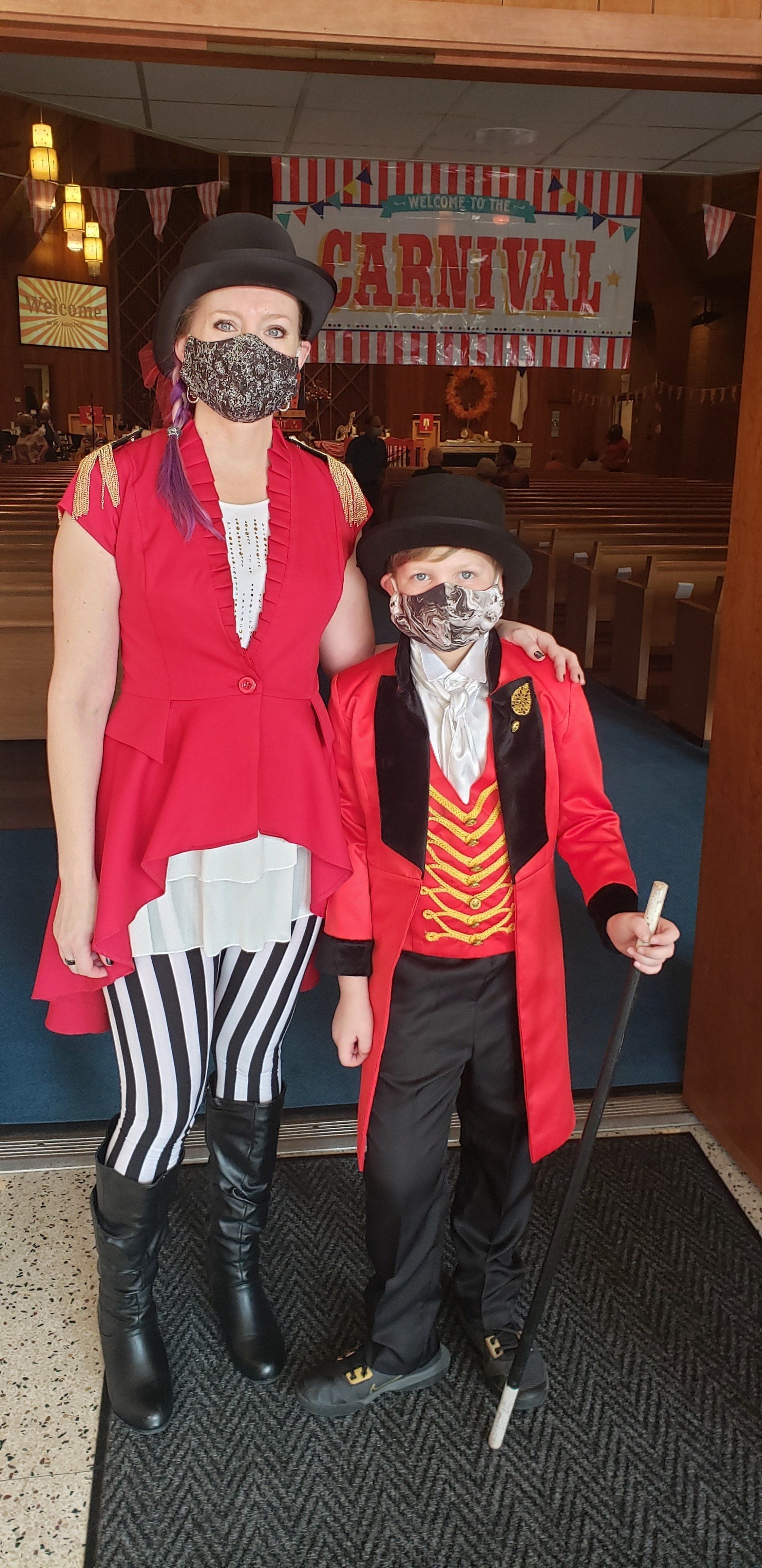 Two mannequins in red and black pirate costumes stand at a shop entrance.