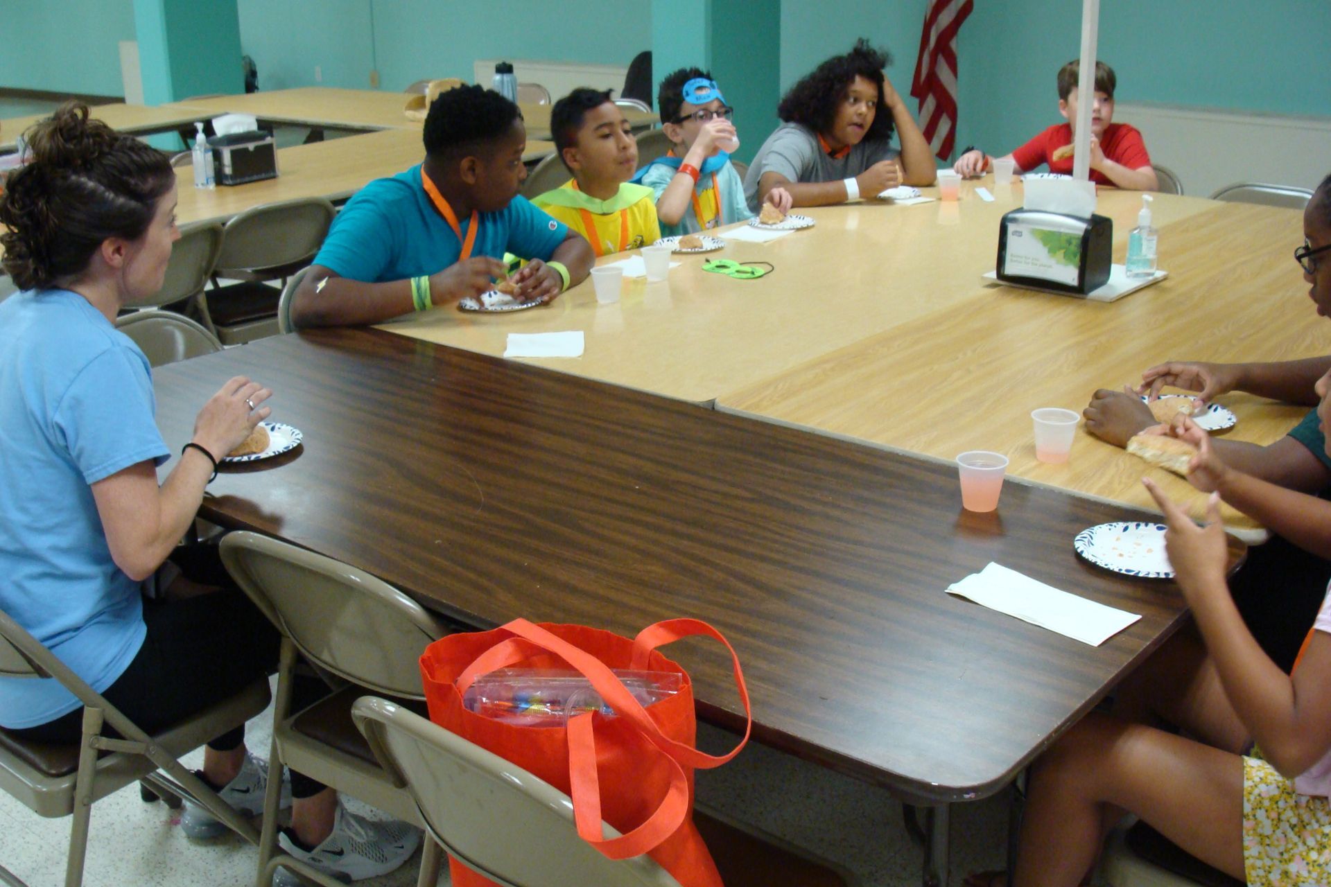 People seated around a table sharing a meal in a meeting room