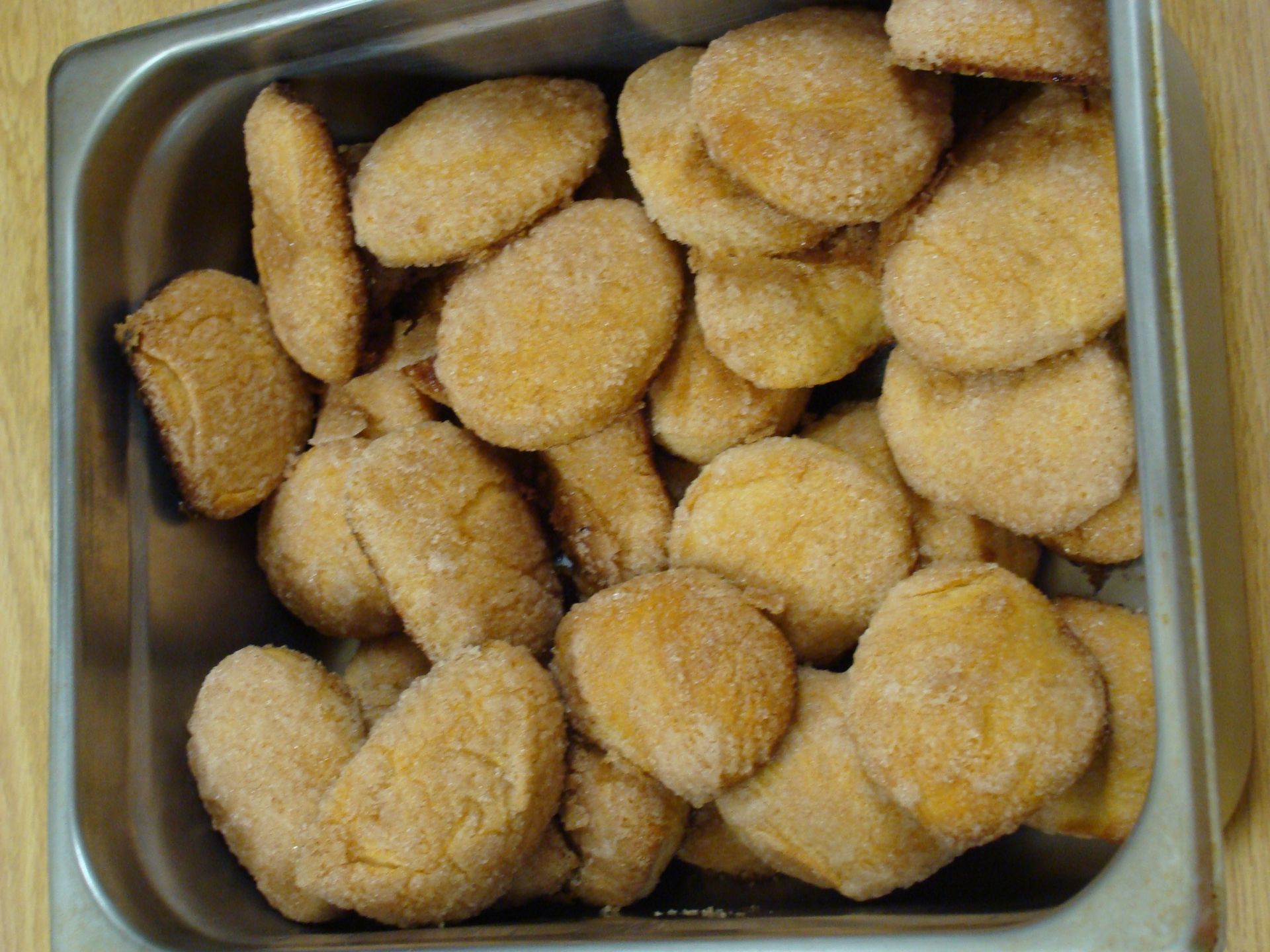 Tray of breaded chicken nuggets in a metal container
