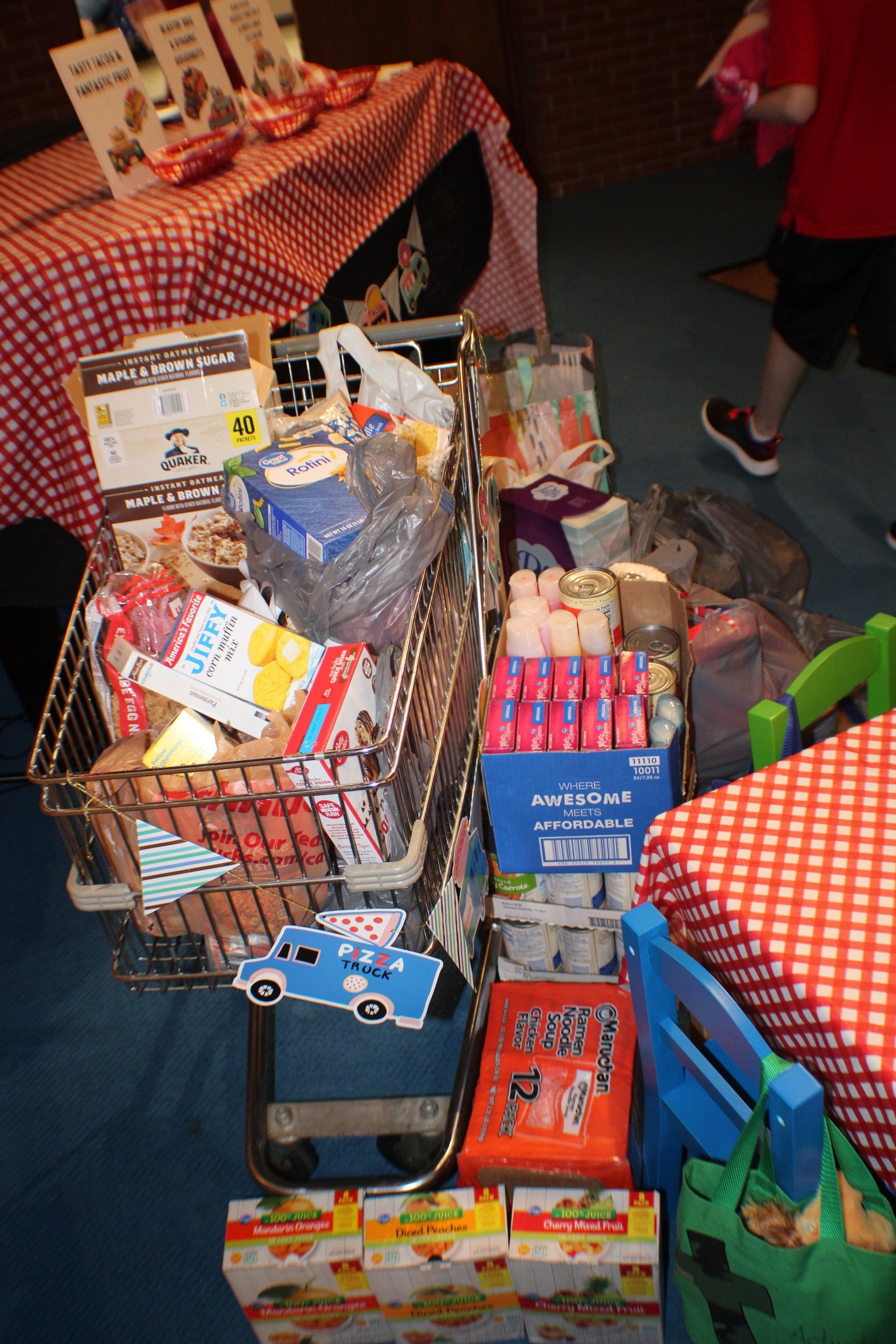 Donation baskets filled with canned and packaged food at a community drive table
