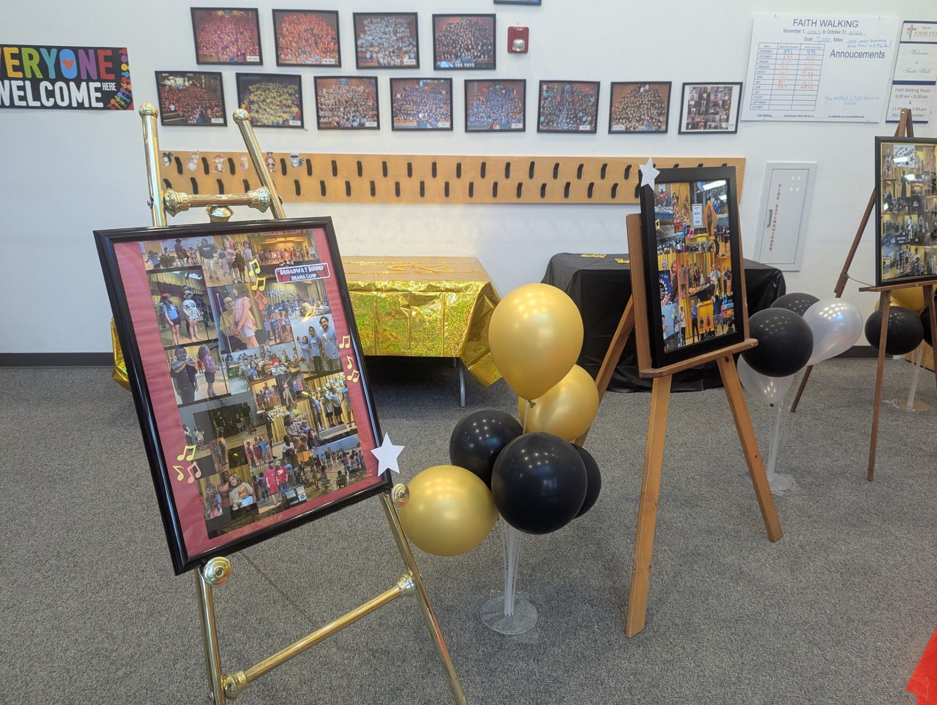 Framed photo collages on easels with black and gold balloons in a decorated room
