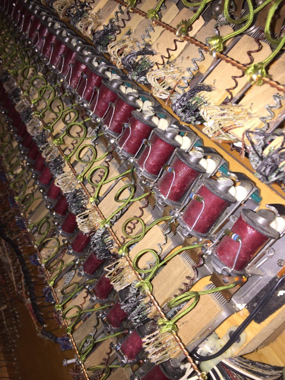 Rows of red and green mechanical components inside an industrial machine frame