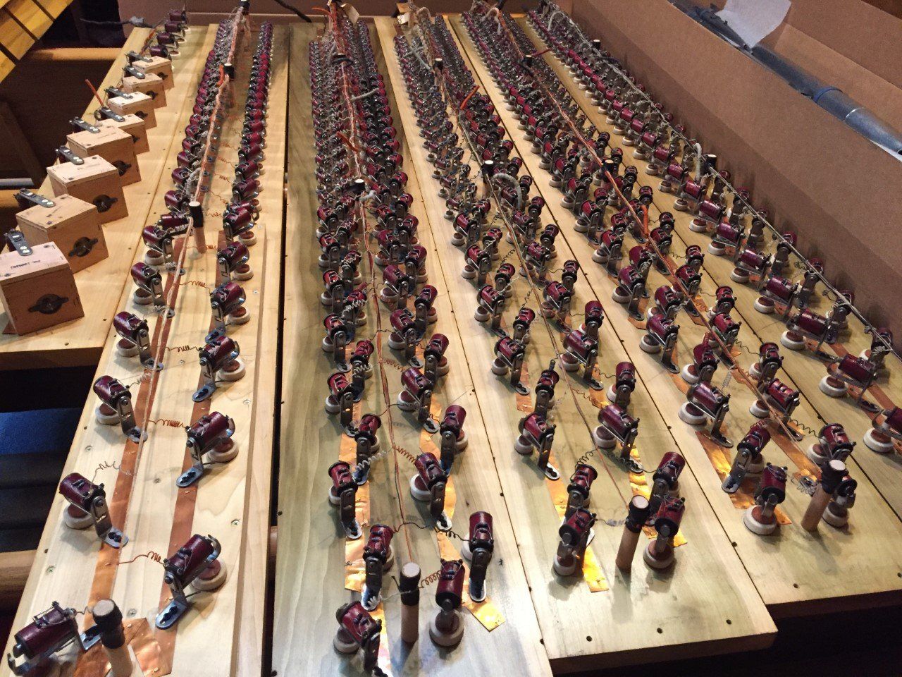Rows of small toy figures lined up on wooden shelves in a large display area