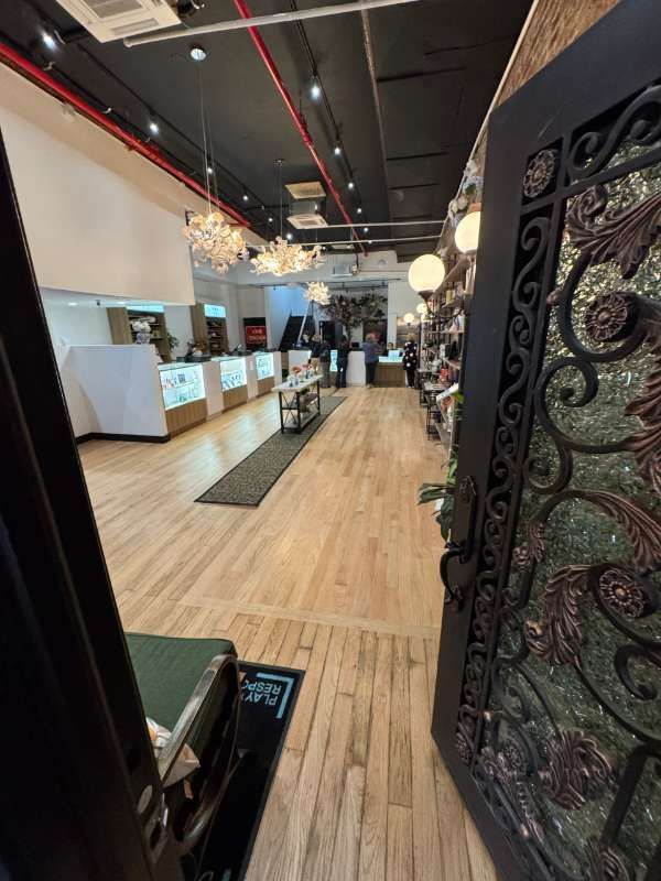 A store with wooden floors and a wrought iron door