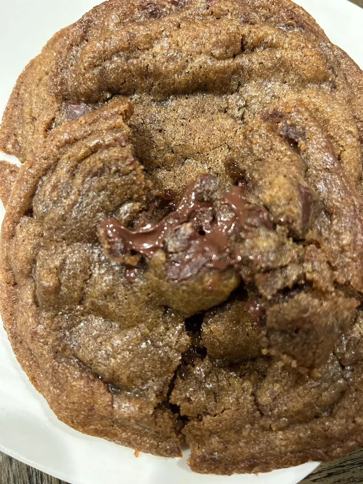 Chocolate cookie, close-up, soft, gooey, with visible melted chocolate chunks.