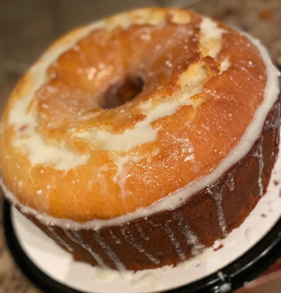 Bundt cake with white glaze dripping down the sides.