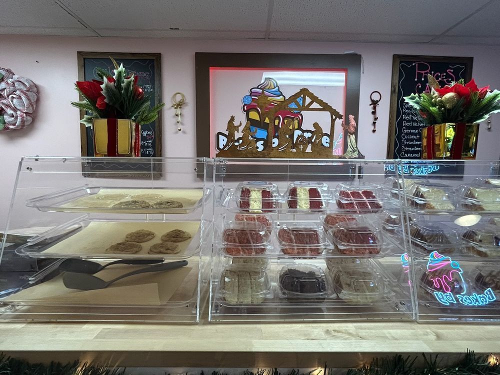 Bakery display case with cookies and treats; Christmas decorations.