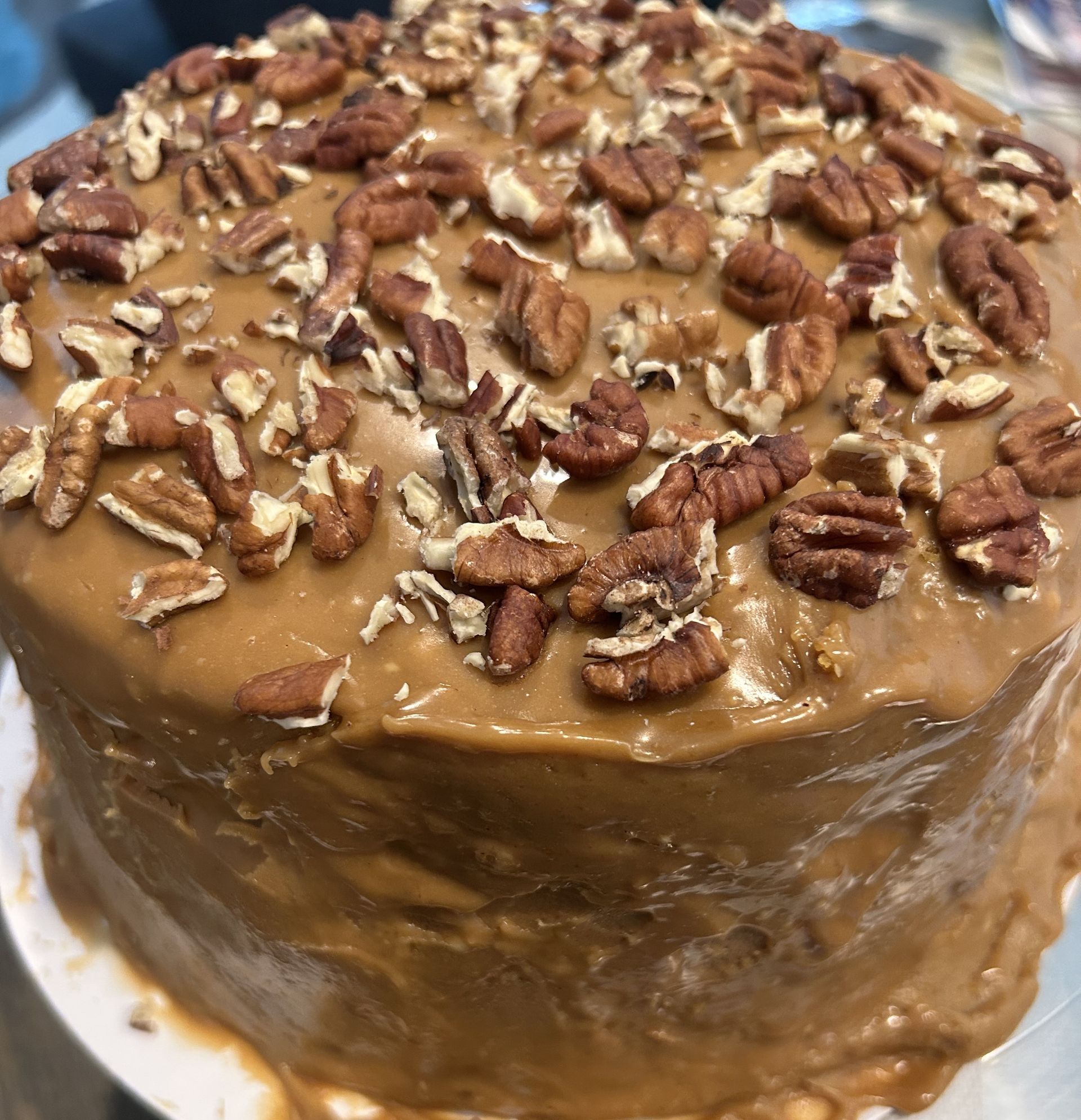 Cake with caramel frosting and pecan topping.
